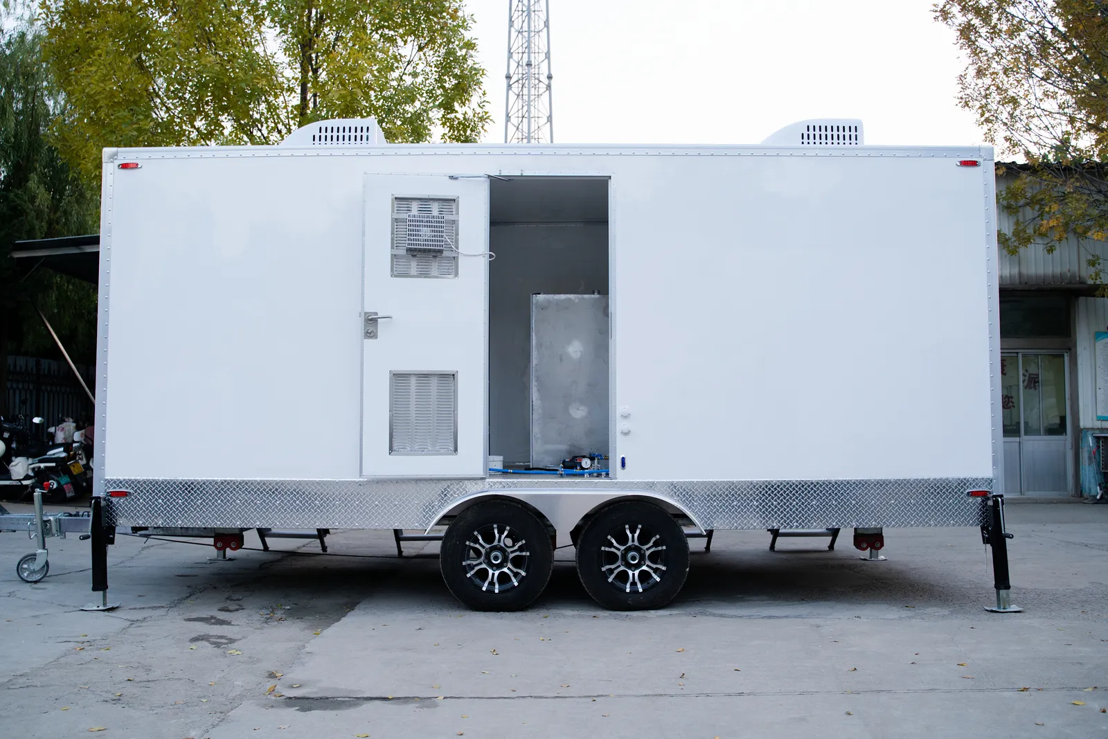 Row of luxury restroom trailers at an outdoor event